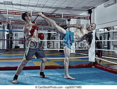 Kickbox fighters in the ring. Two muay thai fighters in a sparring match in the ring. | CanStock