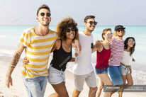 Group of friends walking on the beach — water, friendship - Stock Photo |  #283063130
