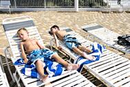 Two Little Boys Sunbathing Lying In Lounge Chairs By A Pool. Stock Photo, Picture And Royalty Free Image. Image 3615447.